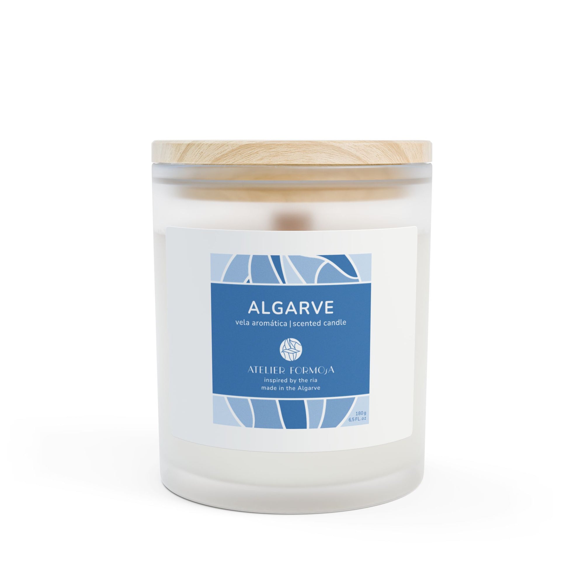  Algarve scented candle in a white jar with blue coastal label, placed on a rustic wooden surface